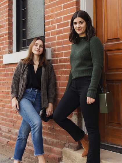 Jacqs and Sara leaning against brick