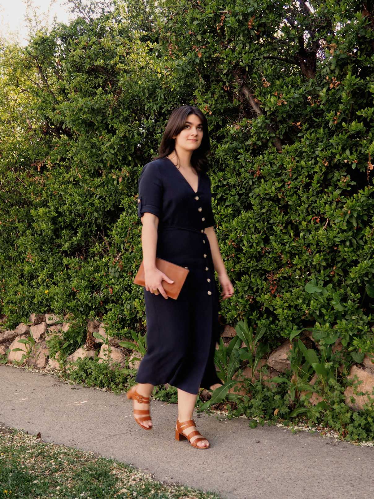 Sara wearing navy blue midi dress with tortoise shell buttons down front