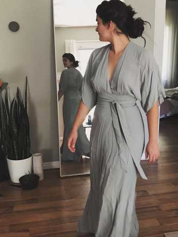 Sara posing in front of mirror with dusty blue kimono-style wrap dress