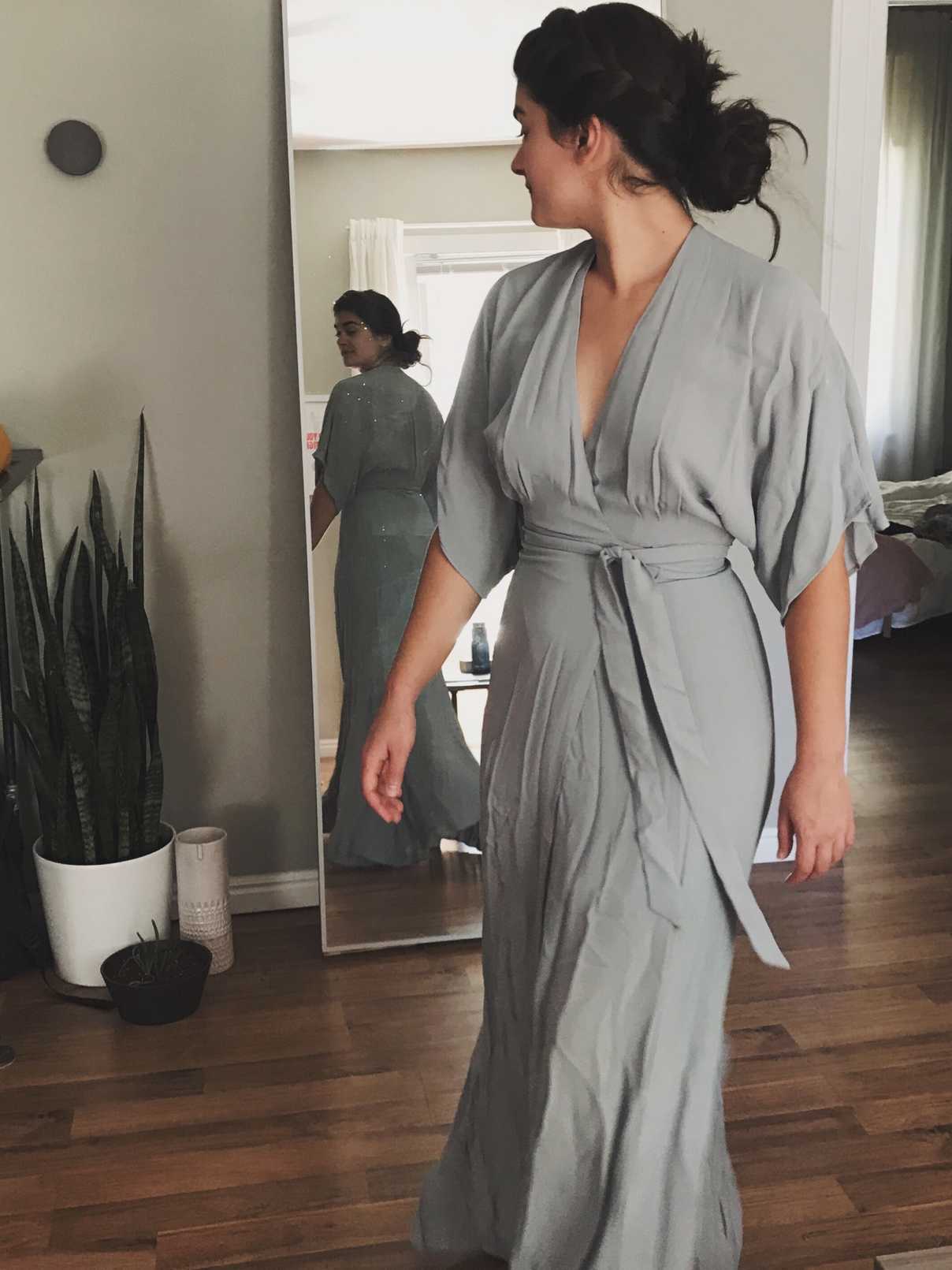 Sara posing in front of mirror with dusty blue kimono-style wrap dress
